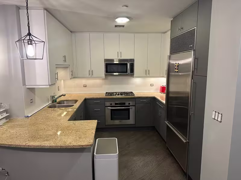 White uppers over gray base cabinets in the refaced kitchen