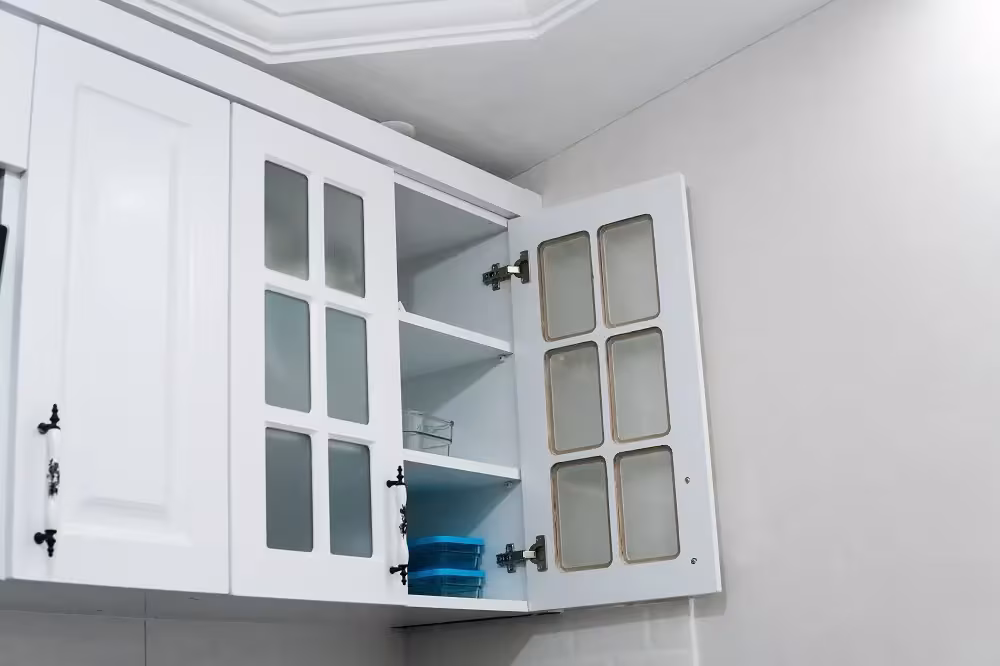 Open white glass-front wall cabinet in an eco-conscious kitchen