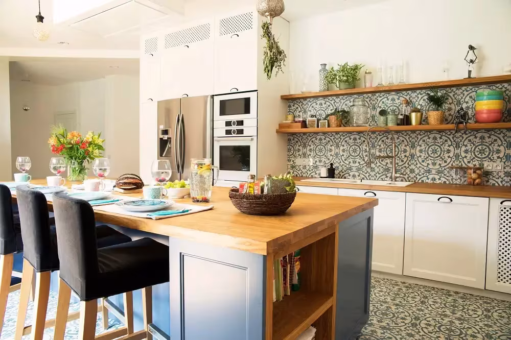 White kitchen with a butcher block island and patterned floor tile