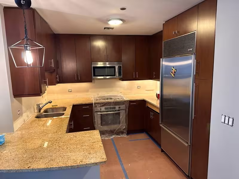 Dark cherry cabinets and granite counters before the refacing project
