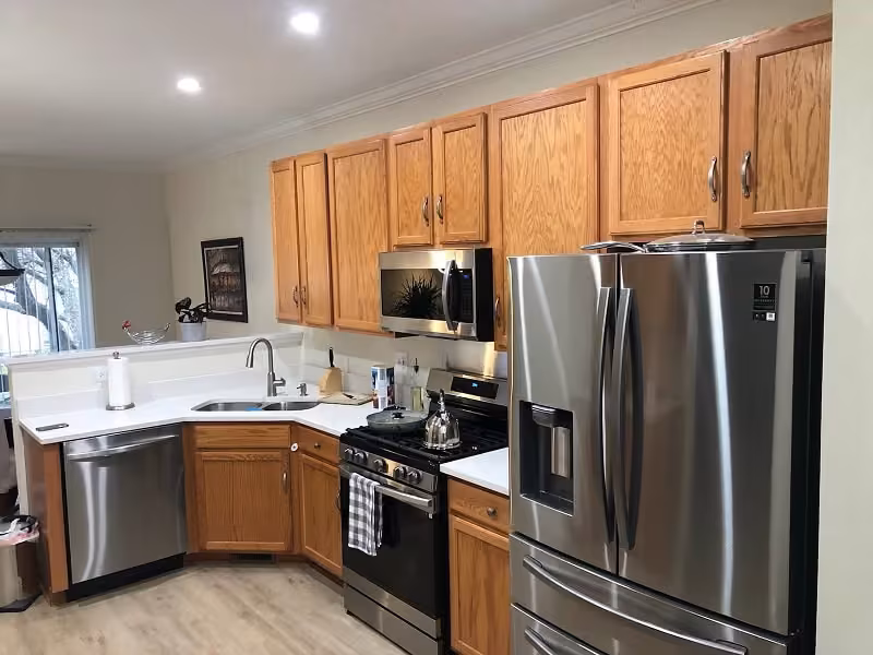 Golden oak cabinets and stainless appliances before refacing