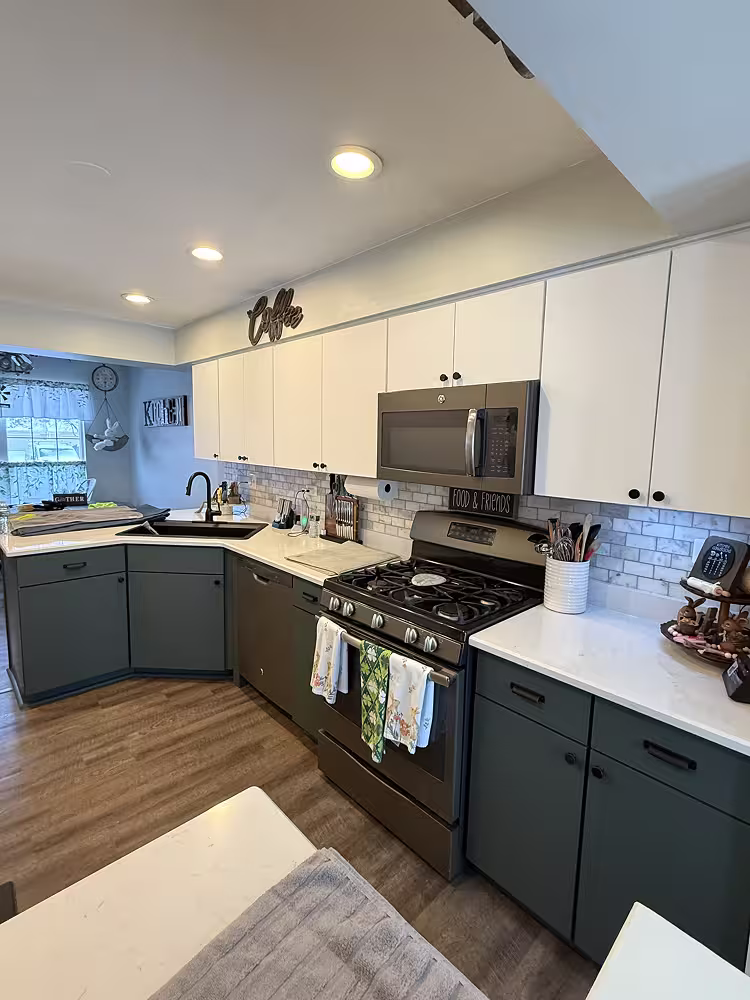 Teal lower cabinets under white uppers before the West Chicago kitchen was unified in one colour