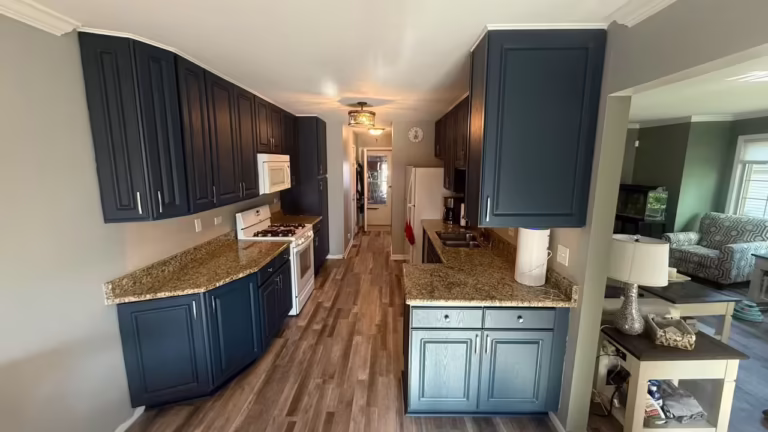 Dark navy cabinets and granite counters after refacing the galley