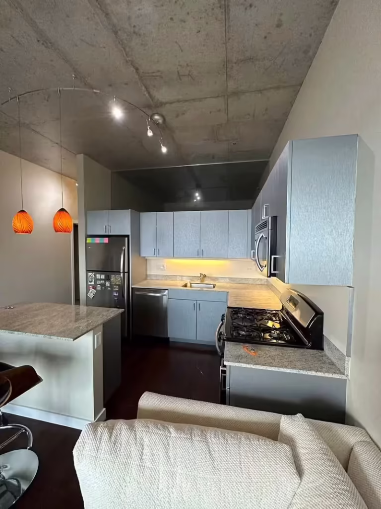 Metallic gray slab doors in the downtown Chicago loft after thermofoil repair