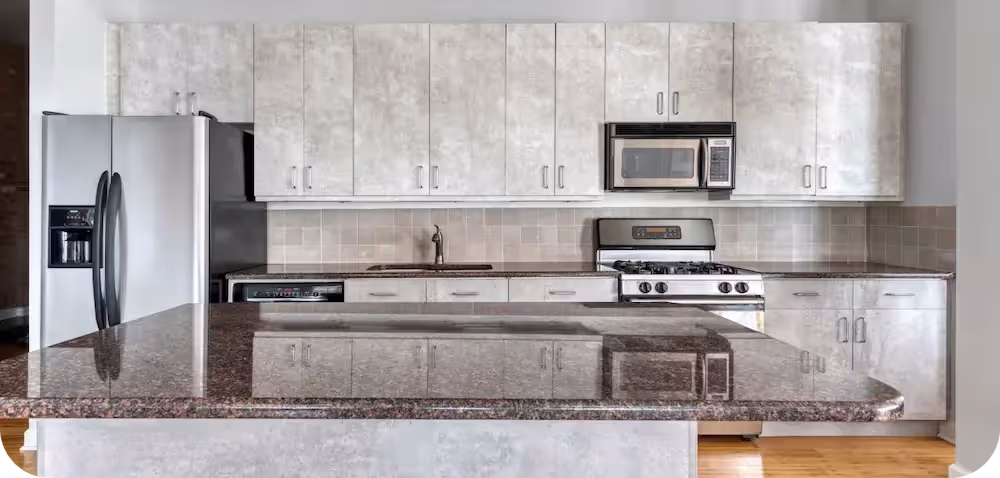 Marble-look slab doors and brown stone countertops in a refaced Northbrook kitchen