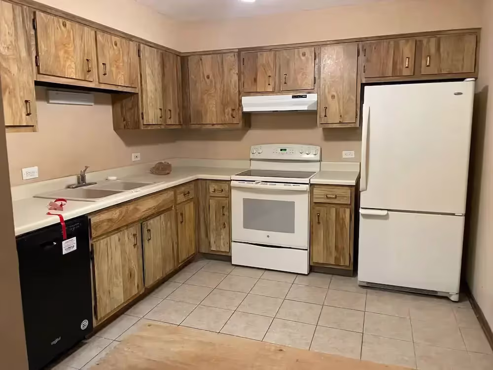 Dated oak cabinets and white appliances in Mount Prospect before the cabinet revamp