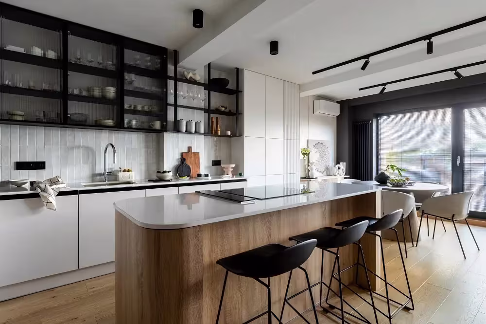 White kitchen with glass-front upper cabinets and a long island