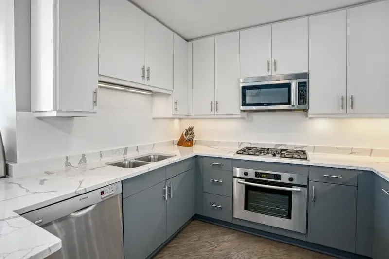 Gray base cabinets and white uppers fitted with new fronts