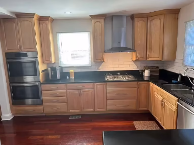Honey oak cabinets and dark counters in Arlington Heights before a pre-sale refacing