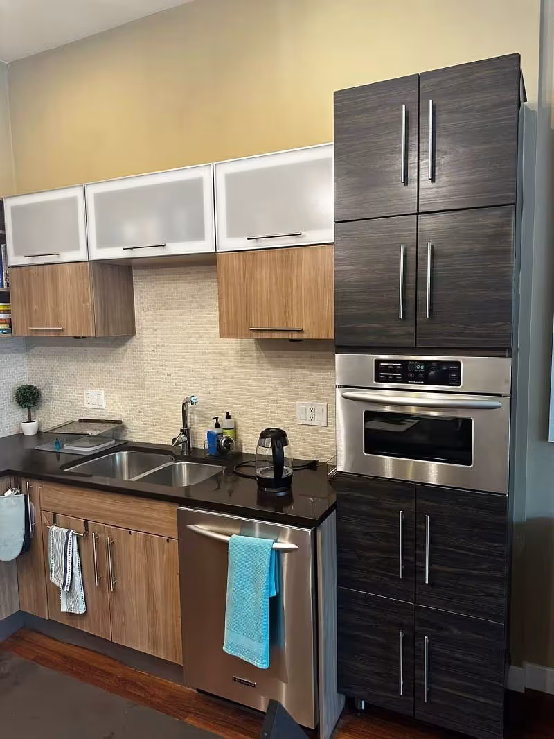 Northbrook kitchen with dark woodgrain and white gloss doors before door replacement