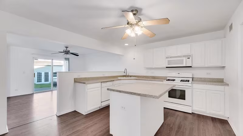 White refaced cabinets and island over dark hardwood flooring