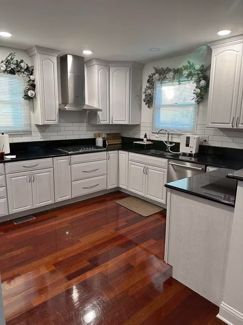 White refaced cabinets and a stainless hood in the Arlington Heights kitchen