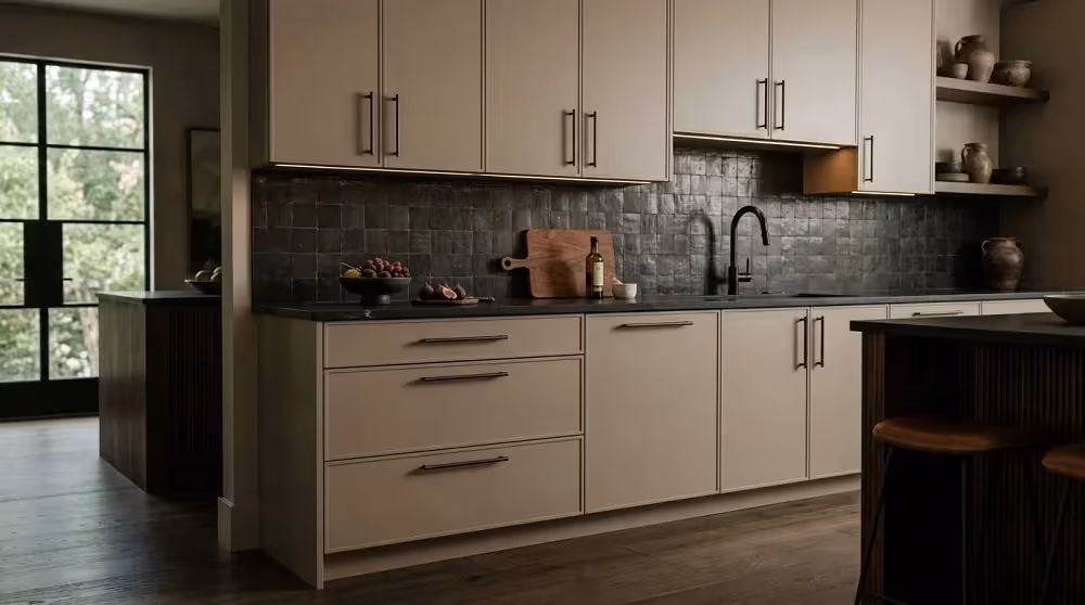 Taupe kitchen modernised with a dark mosaic backsplash
