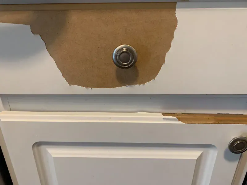 Thermofoil peeling back from the face of a cabinet door